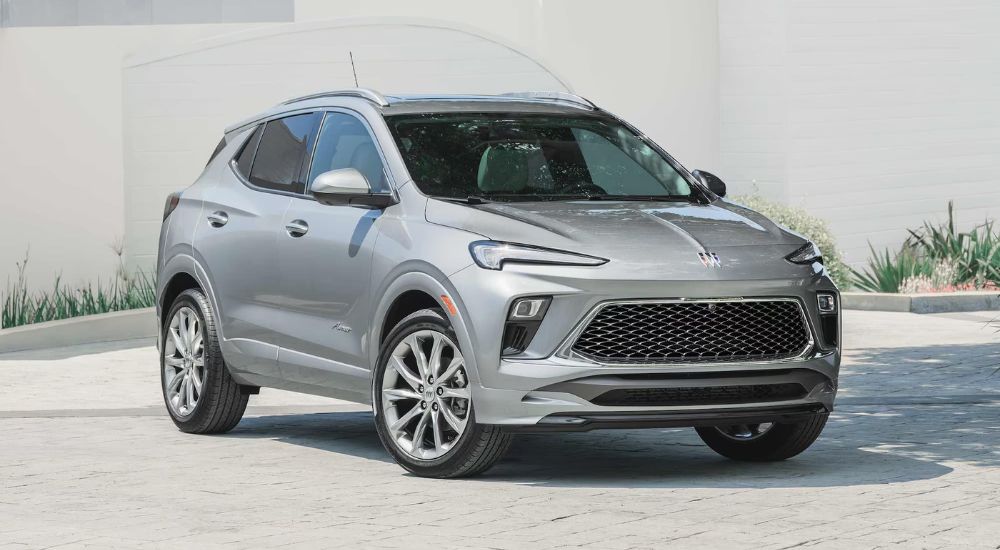 A silver 2025 Buick Encore GX Avenir is shown on concrete after leaving a Buick dealer.