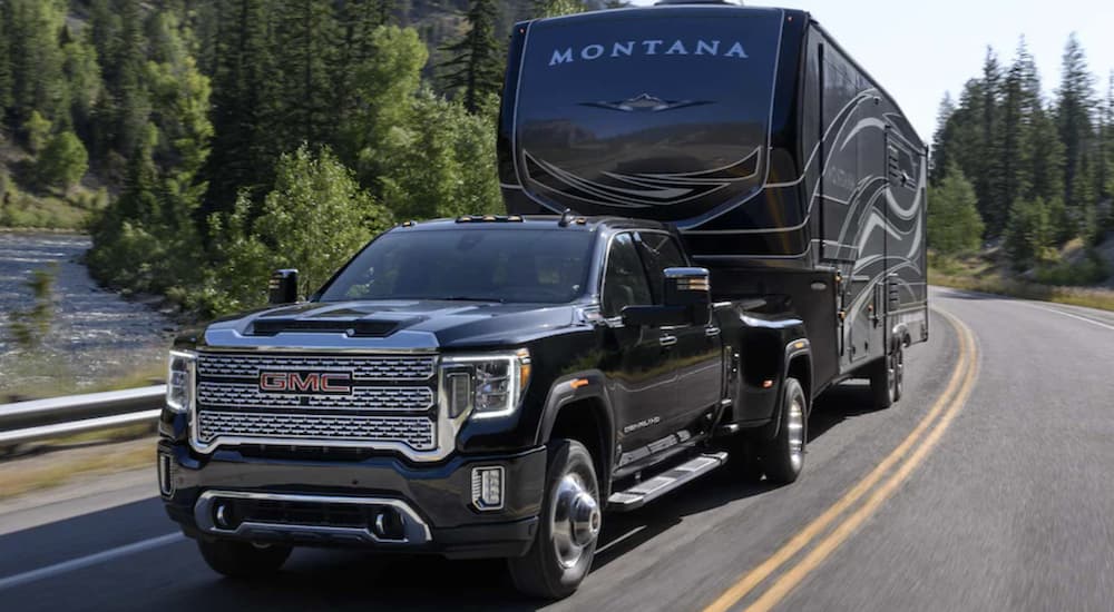 A black 2022 GMC Sierra 1500 towing a trailer.