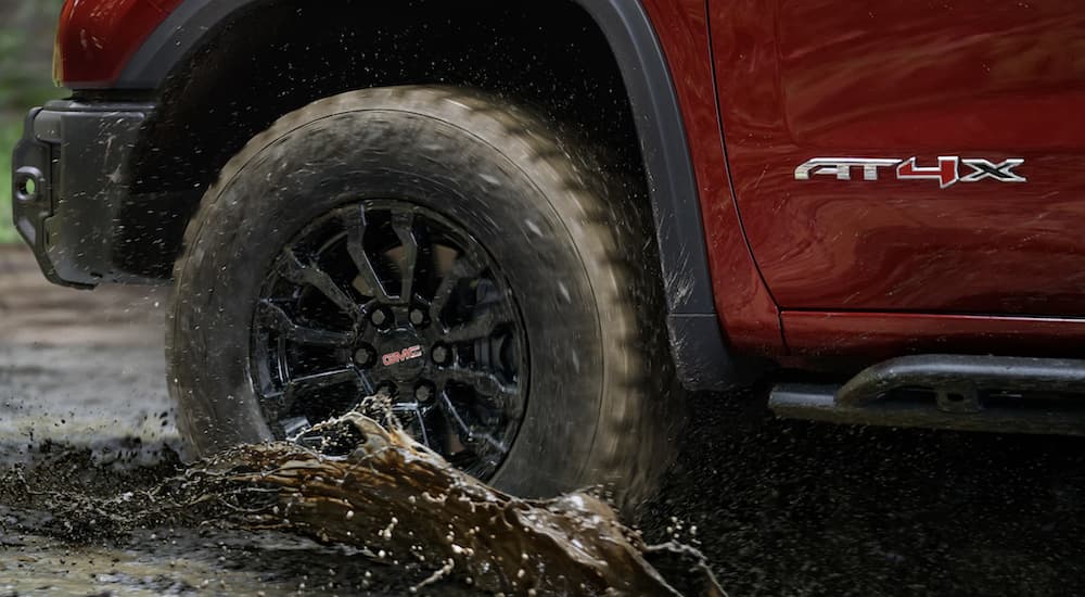Close-up on the wheels of a red 2023 GMC Sierra 1500 AT4X.