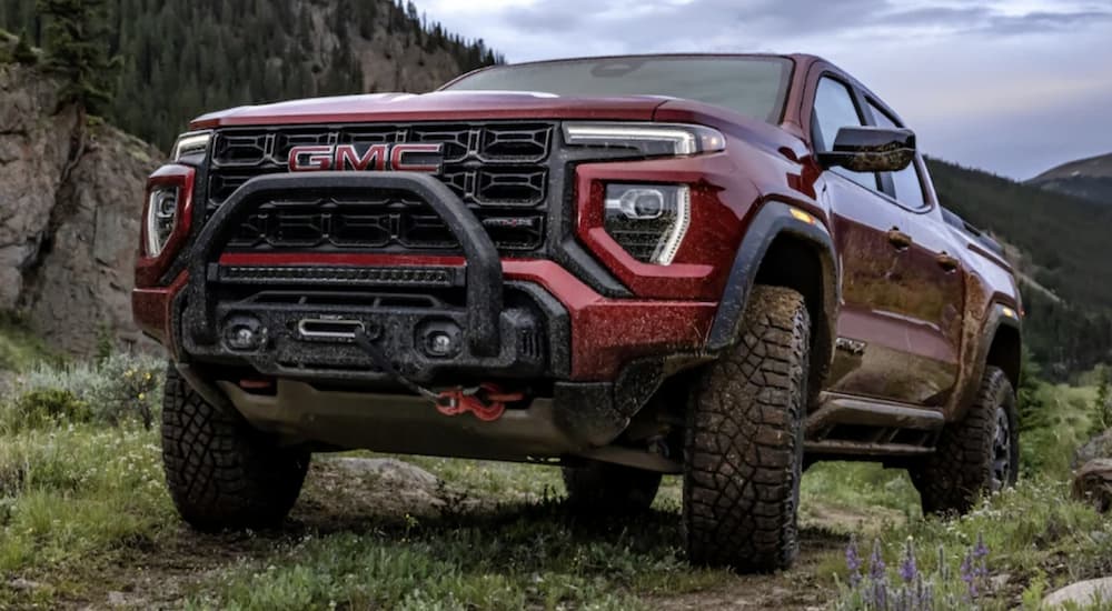 A red 2023 GMC Canyon parked off-road.