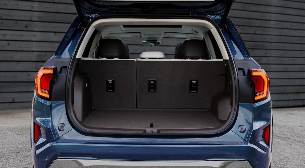 Rear of a dark blue 2026 GMC Terrain with an open hatchback.