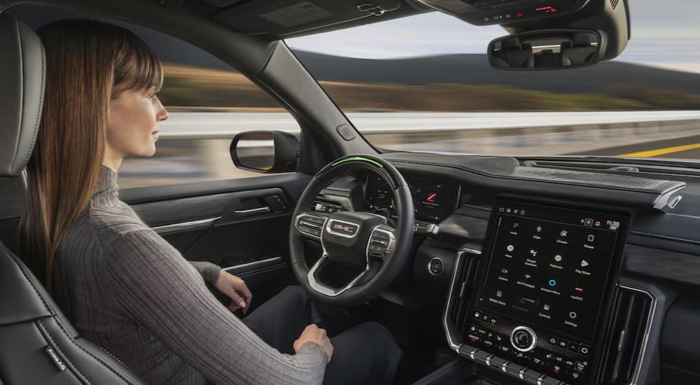 A person using Super Cruise in a 2025 GMC Acadia while driving to a GMC dealer near Morris.