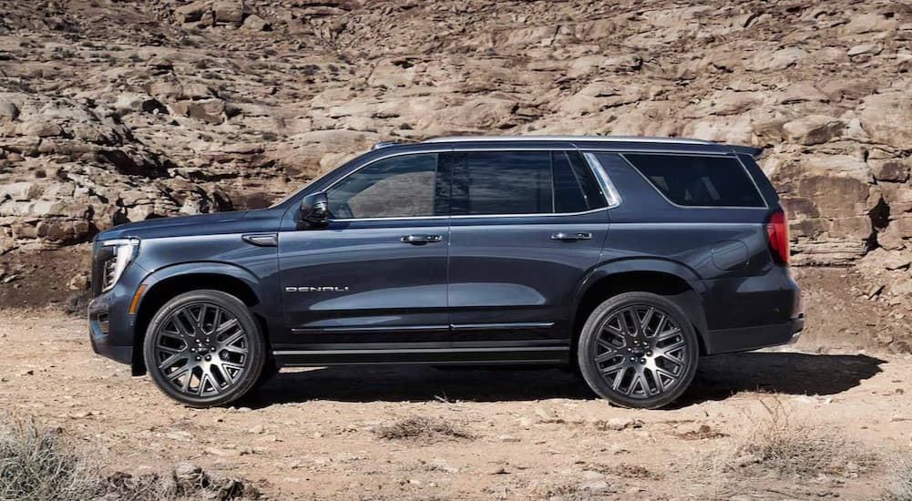 A blue 2025 GMC Yukon parked on sand.