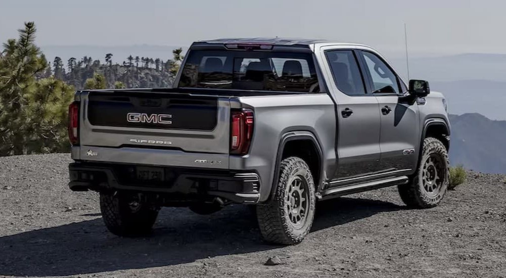 A silver 2025 GMC Sierra 1500 AT4X parked off-road.
