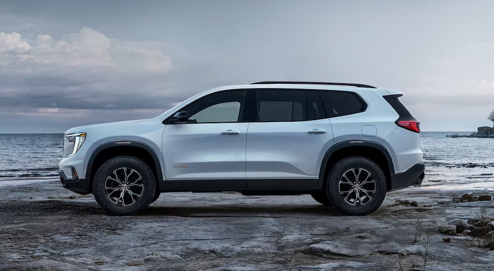 A white 2025 GMC Acadia AT4 parked off-road