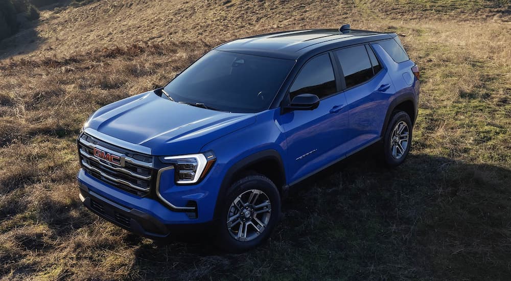High view of a blue 2026 GMC Terrain for sale parked off-road.