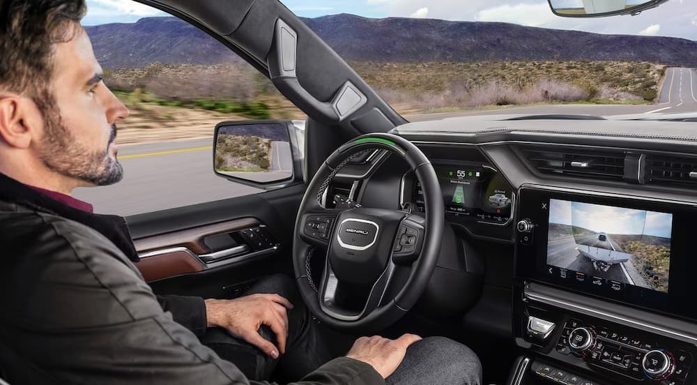A person driving in a 2026 GMC Sierra 1500 for sale near Streator.
