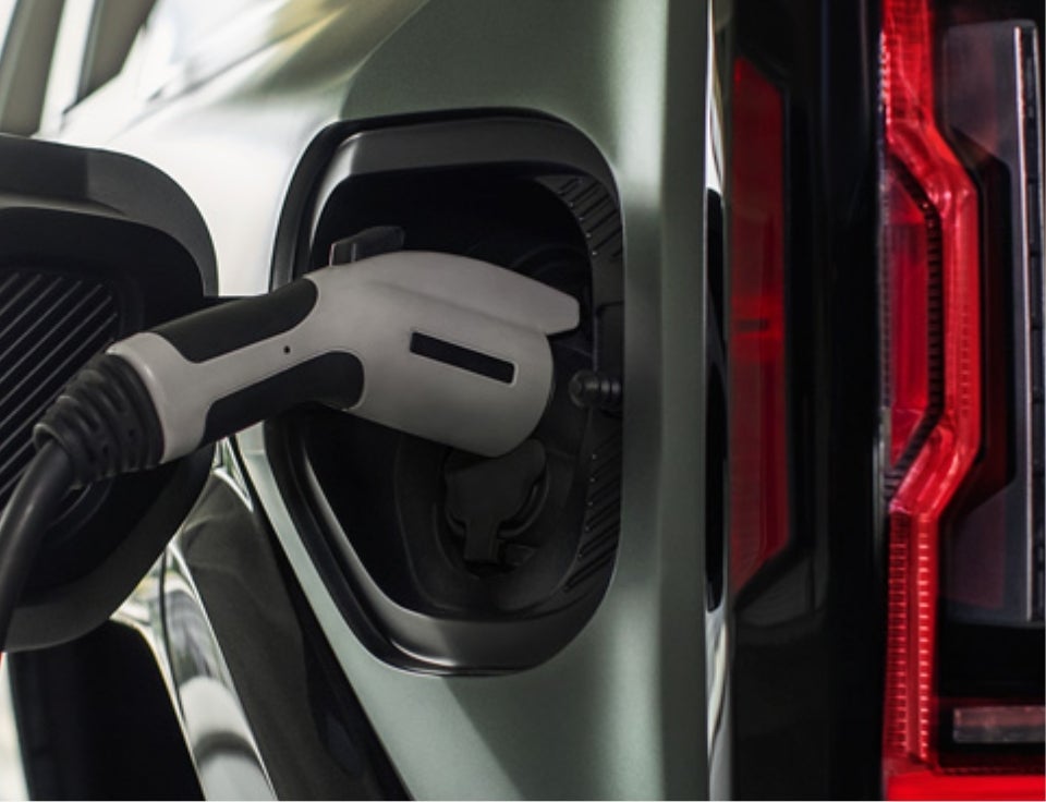 Close up of charging port with charger plugged in on a GMC Hummer EV SUV - Jeff Perry Buick GMC in Peru IL