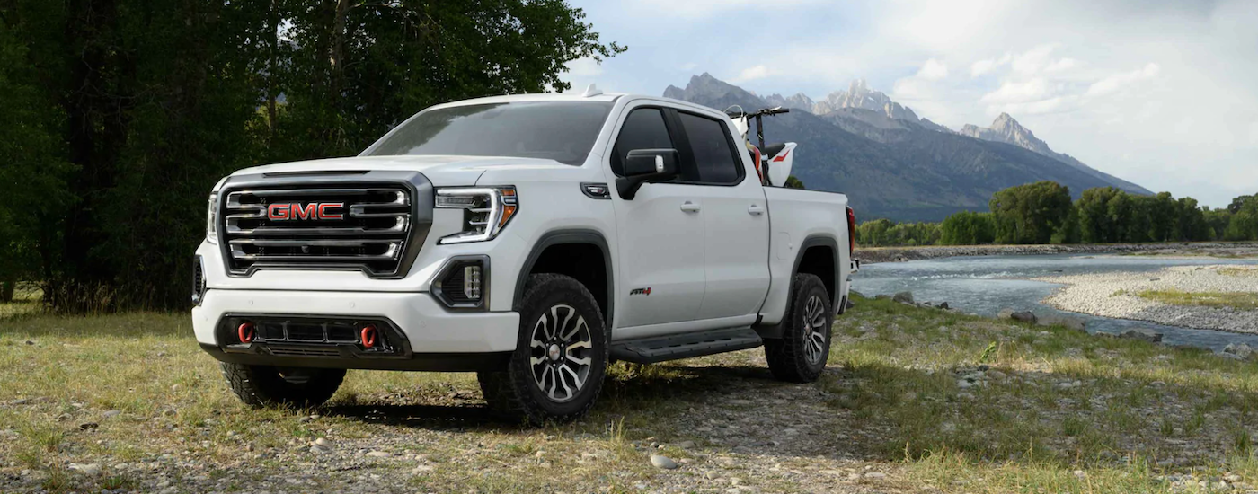 White 2021 GMC Sierra 1500 parked off-road on an angle