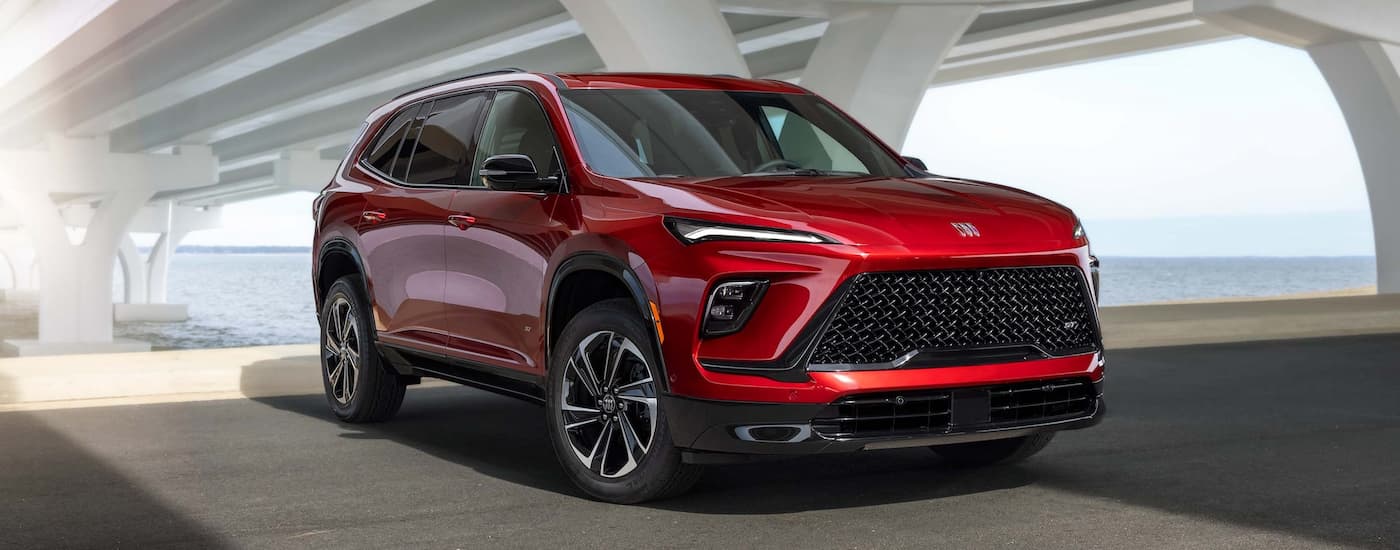 Red 2026 Buick Enclave parked beneath a bridge.