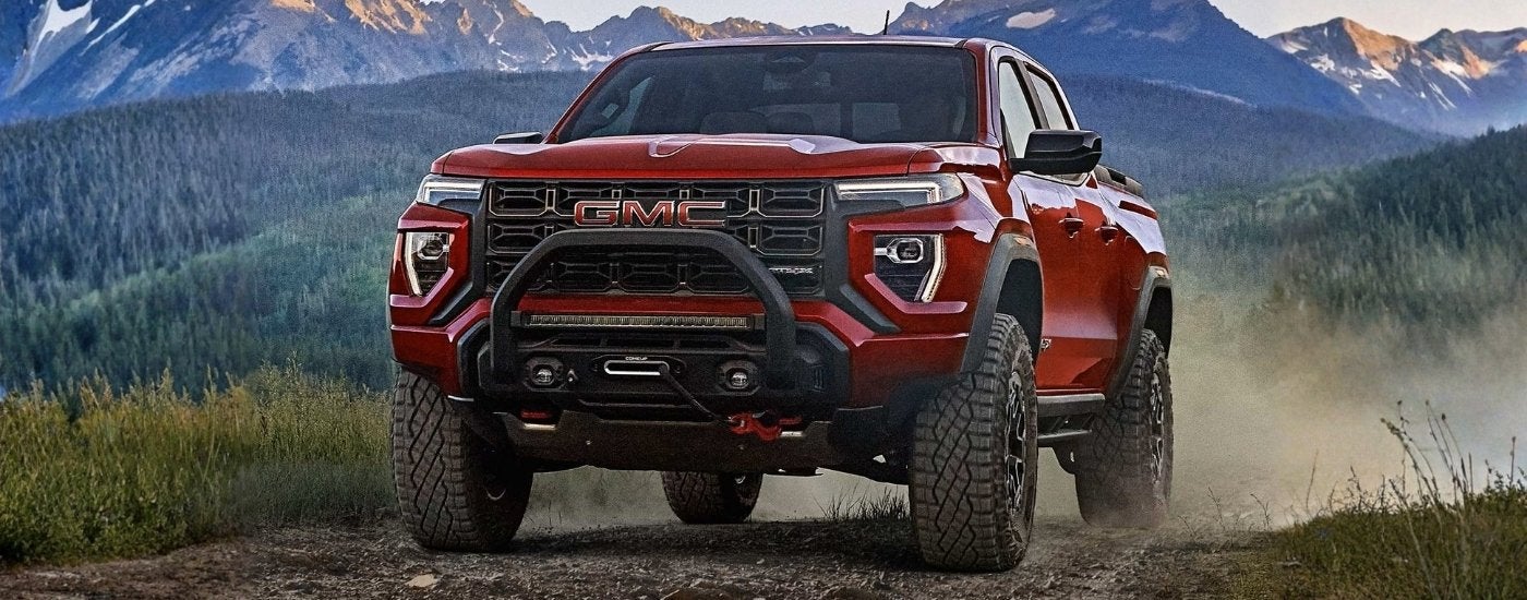 Red 2025 GMC Canyon AT4X driving off-road