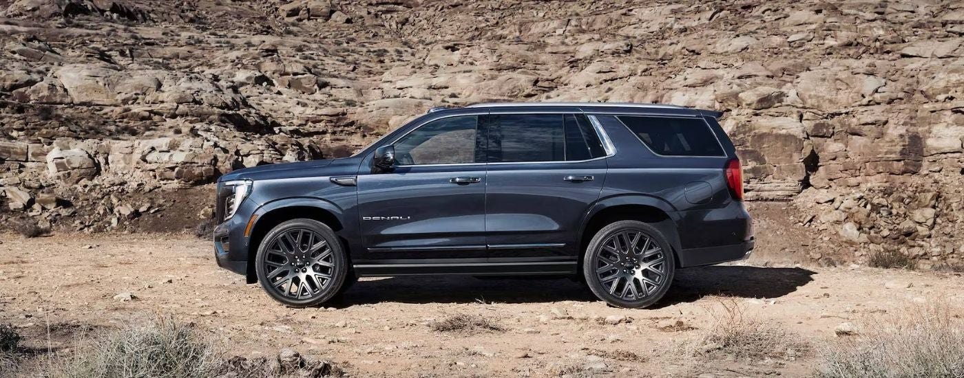 Side look at a black GMC Yukon Denali parked off-road
