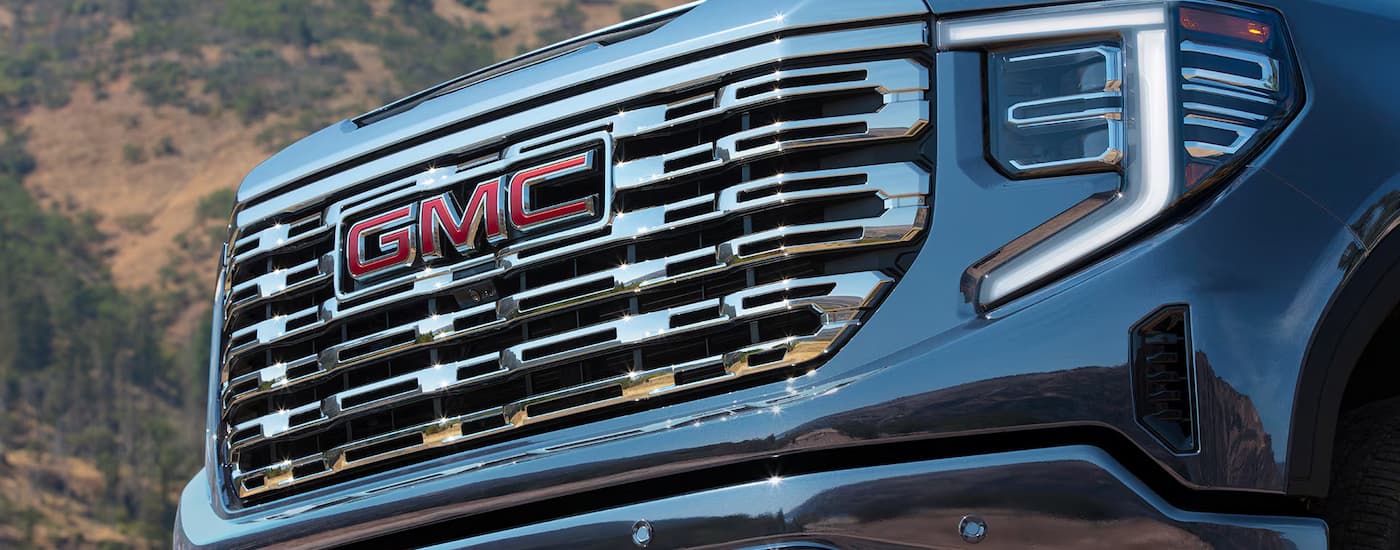 Grille and headlights on a blue 2026 GMC Sierra 1500