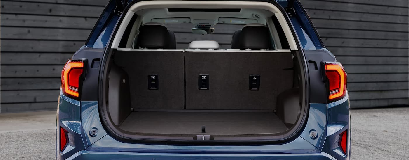 Open trunk in the rear of a blue 2026 GMC Terrain