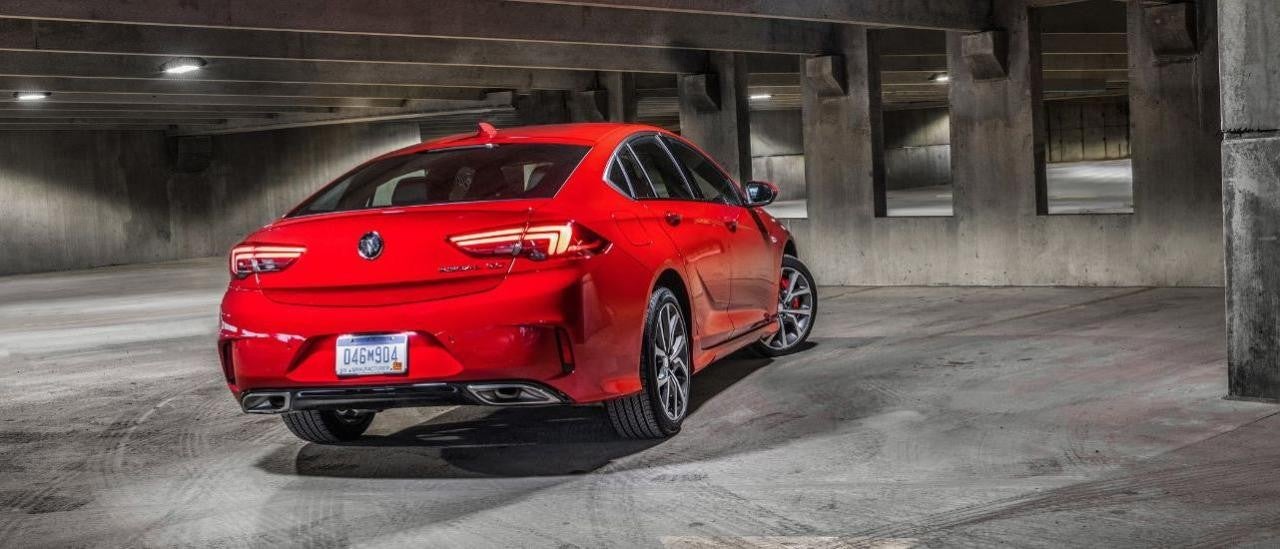 A red 2019 Buick Regal GS is shown from the rear parked in a parking garage.