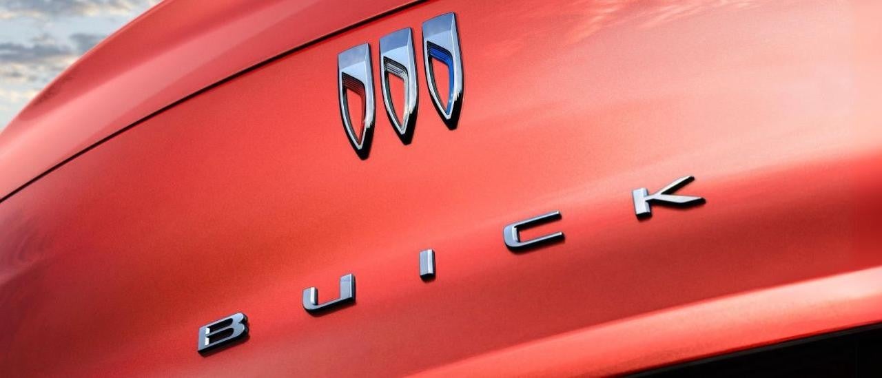  A close up shows the trunk badging on a red 2024 Buick Envista ST.