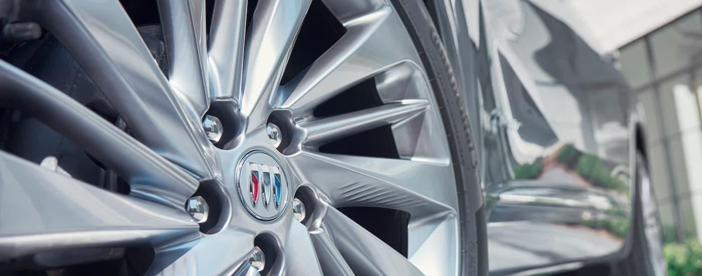 A close up of the rim on a silver 2024 Buick Envision.