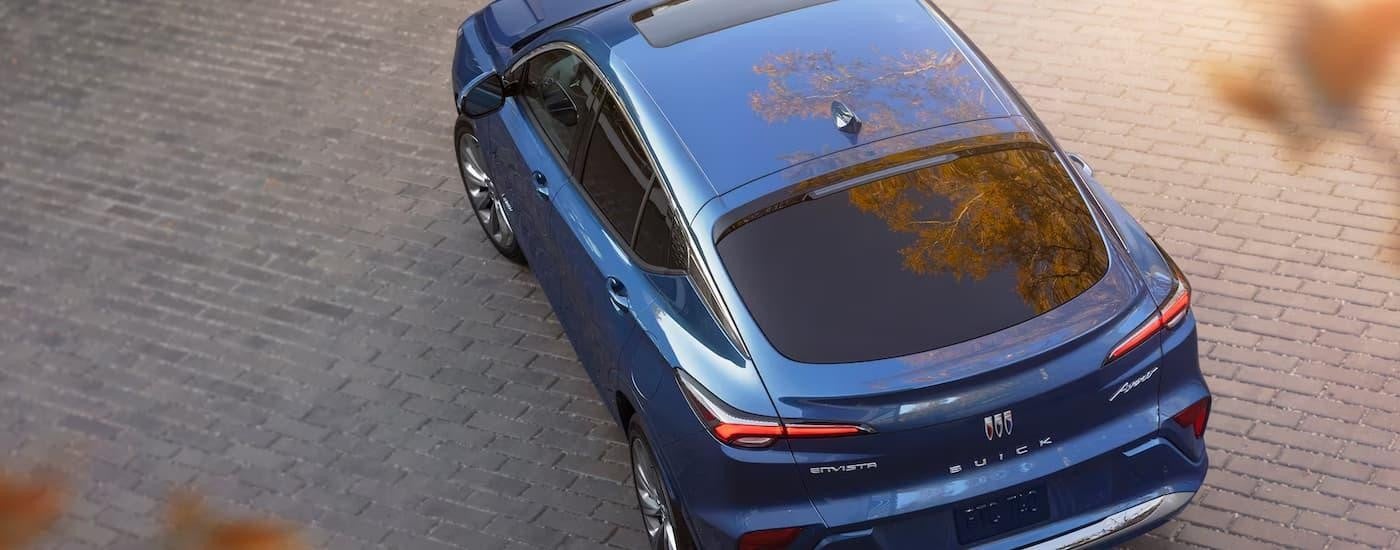 A top down view of a blue 2024 Buick Envista Avenir parked on a stone driveway.