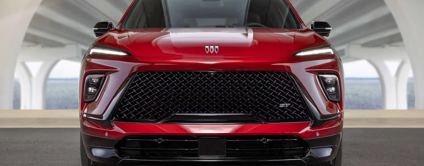 A close up of the grille and front of a red 2025 Buick Enclave ST for sale.