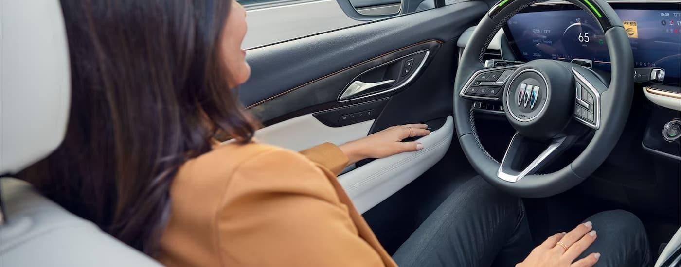 A woman is using the SuperCruise feature in a 2024 Buick Envision.