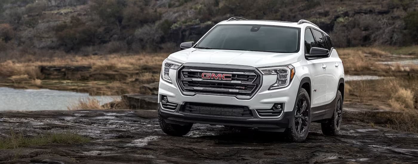 White 2024 GMC Terrain AT4 driving through a marsh.