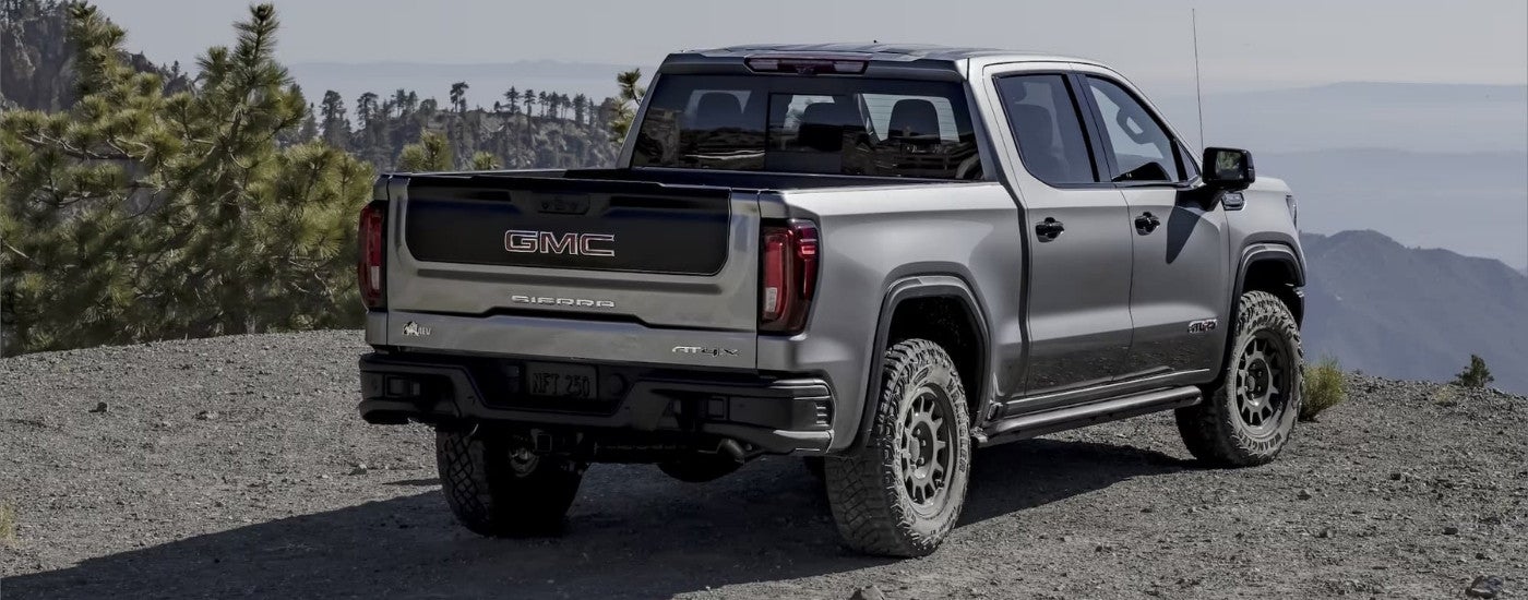 A grey 2023 GMC Sierra AT4X is parked at an overlook.